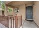 Inviting front porch features a cozy space with railings, complemented by the home's exterior at 9141 Careful Canvas Ave, Las Vegas, NV 89149