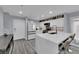 Bright kitchen featuring a large island, modern appliances, white cabinets, and stylish countertops at 9141 Careful Canvas Ave, Las Vegas, NV 89149