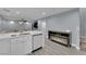 Modern kitchen with a bar sink, built-in dishwasher, a fireplace, and an open floor plan at 9141 Careful Canvas Ave, Las Vegas, NV 89149