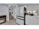 Bright kitchen featuring modern appliances, white cabinets, countertops, and wood-look floors at 9141 Careful Canvas Ave, Las Vegas, NV 89149