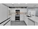 Clean kitchen with stainless steel appliances, a kitchen island, white cabinets, and modern fixtures at 9141 Careful Canvas Ave, Las Vegas, NV 89149
