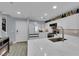 Modern kitchen featuring white cabinets, marble countertops, and stainless steel appliances at 9141 Careful Canvas Ave, Las Vegas, NV 89149