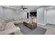 Spacious living room with a large sectional sofa, ceiling fan, and modern decor at 9141 Careful Canvas Ave, Las Vegas, NV 89149