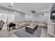 Comfortable living room with large sectional sofa, ceiling fan, and wood-style flooring at 9141 Careful Canvas Ave, Las Vegas, NV 89149