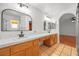 Bright bathroom with dual sinks, tile countertops, and wood cabinets offering ample storage space at 9520 Rancho Palmas Dr, Las Vegas, NV 89117