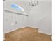 Bright foyer boasts soaring ceilings, a decorative chandelier, and wood look flooring at 9520 Rancho Palmas Dr, Las Vegas, NV 89117