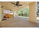 Covered patio with ceiling fans and a hot tub overlooking the yard at 9520 Rancho Palmas Dr, Las Vegas, NV 89117