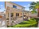 Backyard with a covered patio, a seating area, a water fountain, and artificial grass at 9522 Arrowhead Falls Ct, Las Vegas, NV 89148
