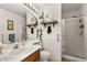 Bright bathroom boasts double sinks, decorative wall accents, and a glass-enclosed shower for a spa-like experience at 9522 Arrowhead Falls Ct, Las Vegas, NV 89148