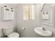 Bathroom featuring white cabinets, a decorative mirror, and a pedestal sink at 9522 Arrowhead Falls Ct, Las Vegas, NV 89148