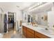 Bathroom with double sinks, large mirror, a shower, and walk in closet at 9522 Arrowhead Falls Ct, Las Vegas, NV 89148