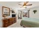 Bright bedroom features a ceiling fan, large mirror and window offering natural light at 9522 Arrowhead Falls Ct, Las Vegas, NV 89148