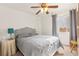 Cozy bedroom features a ceiling fan, a window with natural light, and a comfortable bed with decorative headboard at 9522 Arrowhead Falls Ct, Las Vegas, NV 89148