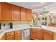 Kitchen with stainless steel appliances, tile counters, and a breakfast bar overlooking the dining area at 9522 Arrowhead Falls Ct, Las Vegas, NV 89148