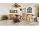 Comfortable living room with plush sofas, a ceiling fan, and decorative accents throughout at 9522 Arrowhead Falls Ct, Las Vegas, NV 89148