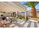 Backyard patio features a pergola, water feature, dining area, and a grill for outdoor living and entertaining at 9522 Arrowhead Falls Ct, Las Vegas, NV 89148