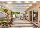 Backyard patio featuring a pergola, a water fountain, artificial turf, and a dining area for outdoor entertaining at 9522 Arrowhead Falls Ct, Las Vegas, NV 89148