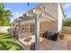 The covered patio offers artificial turf, a water feature, and an outdoor dining area perfect for enjoying outdoor meals at 9522 Arrowhead Falls Ct, Las Vegas, NV 89148