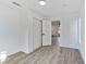 Bright bedroom featuring laminate floors, closet and ceiling mounted light fixture at 9541 Summersweet Ct, Las Vegas, NV 89123