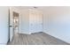 Bedroom featuring wood-look floors, white walls, and a closet with sliding doors at 9541 Summersweet Ct, Las Vegas, NV 89123