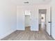 Bright bedroom with white walls, wood-look floors, and a closet and doorways at 9541 Summersweet Ct, Las Vegas, NV 89123