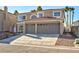 Attractive two-story residence showcasing a three-car garage and manicured front yard appeal at 9541 Summersweet Ct, Las Vegas, NV 89123