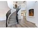 Grand foyer with a curved staircase, high ceilings, and modern architectural details at 9541 Summersweet Ct, Las Vegas, NV 89123