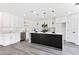 Modern kitchen featuring white cabinets, marble countertops, and stainless steel appliances at 9541 Summersweet Ct, Las Vegas, NV 89123