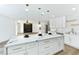Bright kitchen with a marble island, white cabinets, and modern pendant lighting at 9541 Summersweet Ct, Las Vegas, NV 89123