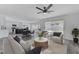Spacious living room with an open floor plan, showcasing a modern kitchen and access to the backyard pool at 9541 Summersweet Ct, Las Vegas, NV 89123