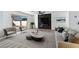 Modern living room with stylish seating, elegant marble fireplace, and a sliding glass door to the backyard at 9541 Summersweet Ct, Las Vegas, NV 89123