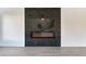 Modern living room with a black marble accent wall with a fireplace at 9541 Summersweet Ct, Las Vegas, NV 89123