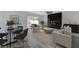 Open concept living room features modern furniture, sleek marble fireplace, and sliding glass doors to the backyard at 9541 Summersweet Ct, Las Vegas, NV 89123