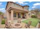 An outdoor living space with a fire pit, seating, and artificial turf in a well-maintained backyard at 9557 Belmont Bay Ave, Las Vegas, NV 89148