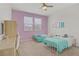 Inviting bedroom featuring twin beds, a ceiling fan, and a study desk at 9557 Belmont Bay Ave, Las Vegas, NV 89148