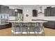 Modern kitchen with a spacious island, stainless steel appliances, granite countertops, and stylish pendant lighting at 9557 Belmont Bay Ave, Las Vegas, NV 89148