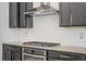 Bright kitchen with gray cabinets, stainless steel appliances and white herringbone tile backsplash at 9557 Belmont Bay Ave, Las Vegas, NV 89148