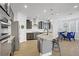 Modern kitchen featuring stainless appliances, granite countertops, and an open dining area at 9557 Belmont Bay Ave, Las Vegas, NV 89148