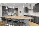 Modern kitchen boasts granite countertops, stainless steel appliances, and a large island with barstool seating at 9557 Belmont Bay Ave, Las Vegas, NV 89148