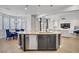 Contemporary kitchen with a large island, pendant lighting and dark-tone cabinets at 9557 Belmont Bay Ave, Las Vegas, NV 89148