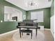 Elegant living room featuring a grand piano, contemporary lighting, and a view to another room at 9557 Belmont Bay Ave, Las Vegas, NV 89148