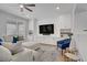 Bright living room with modern built-ins, plush seating, and a ceiling fan at 9557 Belmont Bay Ave, Las Vegas, NV 89148