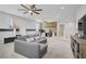Upstairs living area with a home office, media center and comfortable gray sectional for lounging at 9557 Belmont Bay Ave, Las Vegas, NV 89148