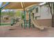 Outdoor play area with a slide and climbing structure beneath a shaded canopy at 9557 Belmont Bay Ave, Las Vegas, NV 89148