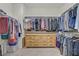 Large walk-in closet with rods, shelves, and a dresser for optimal storage at 9557 Belmont Bay Ave, Las Vegas, NV 89148