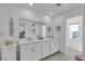 Elegant bathroom featuring double sinks, large mirror, and lots of counterspace at 9605 Oliver Hills Ave, Las Vegas, NV 89143