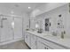 Elegant bathroom featuring double sinks, large mirror, and a glass-enclosed shower at 9605 Oliver Hills Ave, Las Vegas, NV 89143