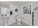 Clean bathroom features a pedestal sink, toilet, and modern decor at 9605 Oliver Hills Ave, Las Vegas, NV 89143