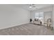 Bright bedroom featuring neutral carpet, chest of drawers, and a ceiling fan at 9605 Oliver Hills Ave, Las Vegas, NV 89143