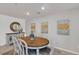 Dining room featuring a wooden table, six chairs, and neutral wall decor at 9605 Oliver Hills Ave, Las Vegas, NV 89143